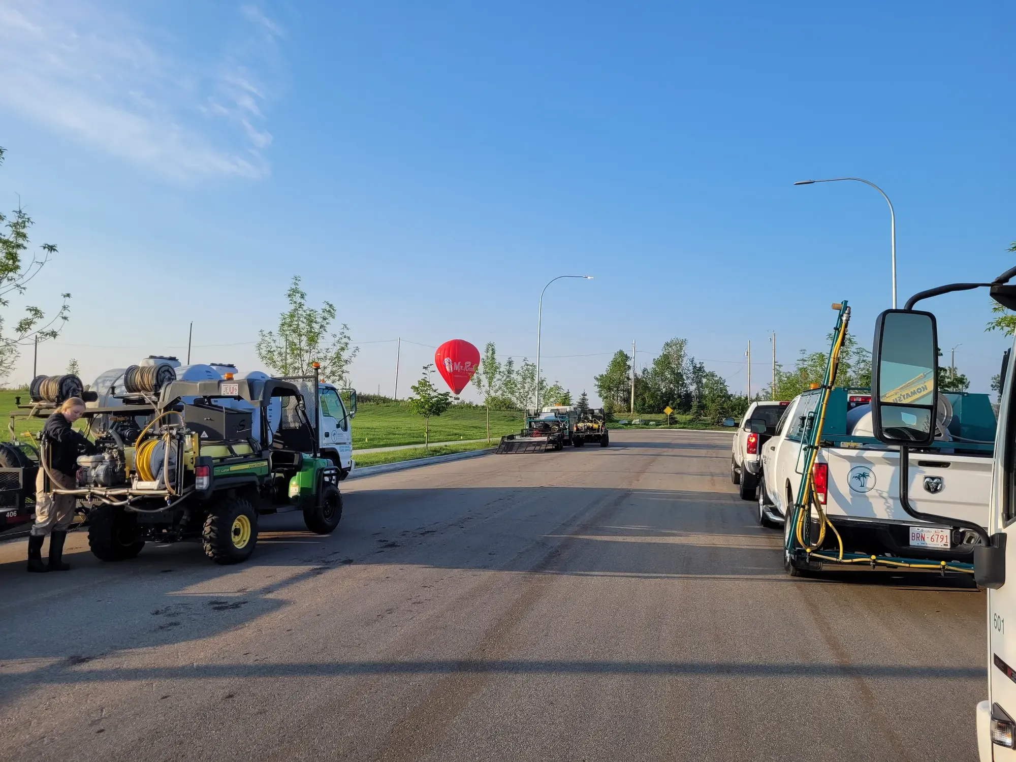 Green Oasis fleet vehicles staged with equipment