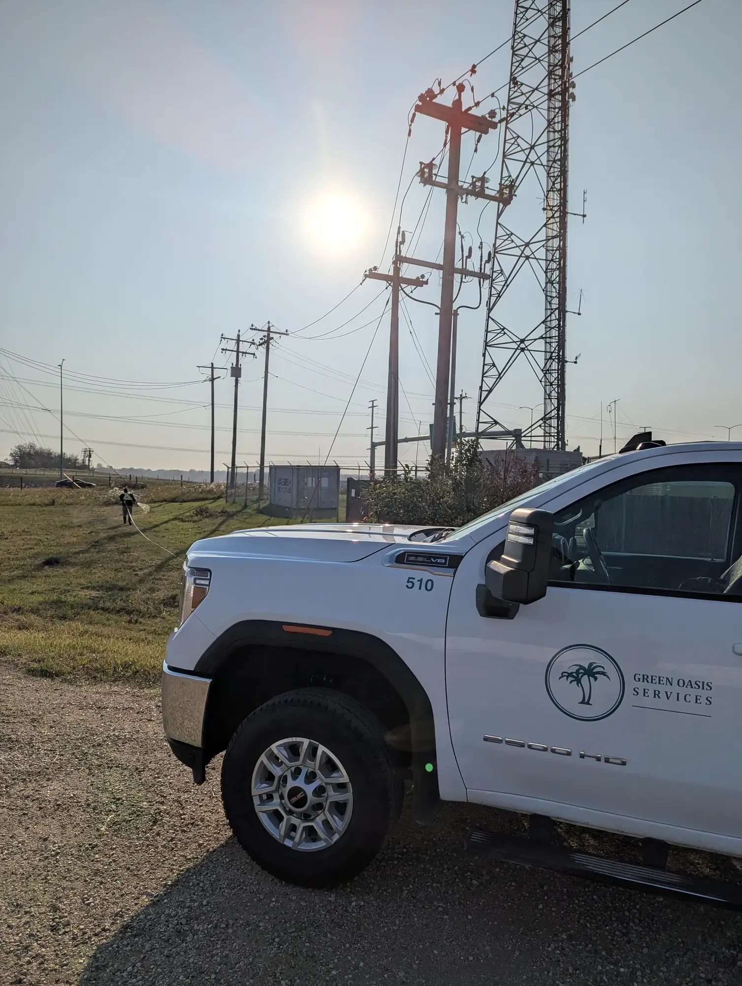 Green Oasis Services truck at industrial power line site